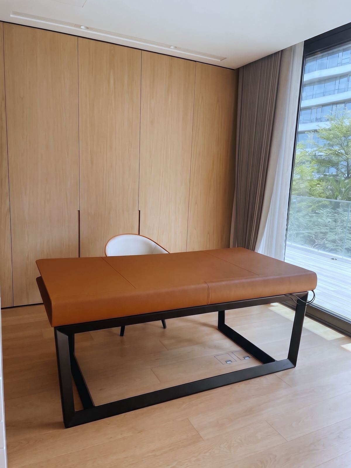 Lounge chair in olive velvet, beside a marble side table
